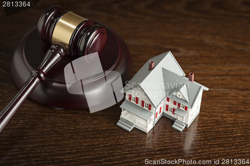 Image of Gavel and Small Model House on Table