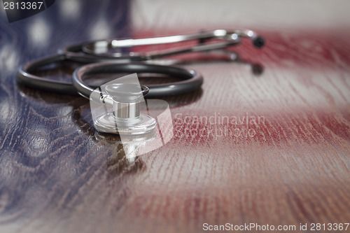 Image of Stethoscope with American Flag Reflection on Table