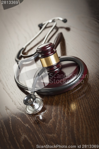 Image of Gavel and Stethoscope on Reflective Table