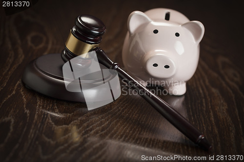 Image of Gavel and Piggy Bank on Table