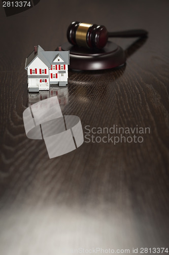 Image of Gavel and Small Model House on Table