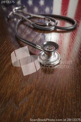 Image of Stethoscope with American Flag Reflection on Table