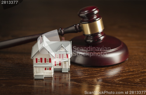 Image of Gavel and Small Model House on Table