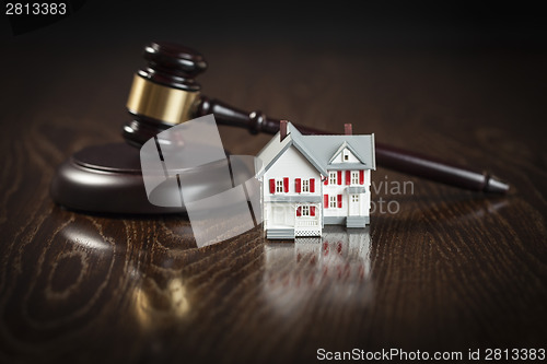 Image of Gavel and Small Model House on Table