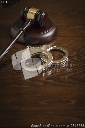 Image of Gavel and Pair of Handcuffs on Table