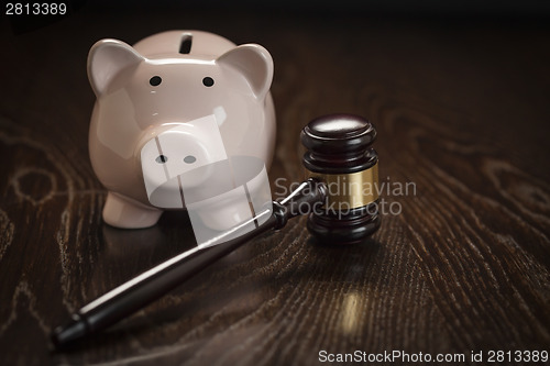 Image of Gavel and Piggy Bank on Table