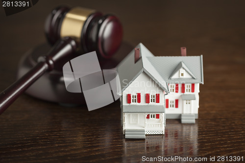 Image of Gavel and Small Model House on Table