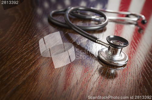 Image of Stethoscope with American Flag Reflection on Table