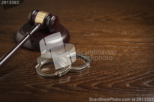 Image of Gavel and Pair of Handcuffs on Table