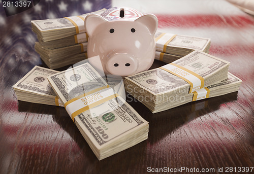 Image of Thousands of Dollars, Piggy Bank, American Flag Reflection on Ta