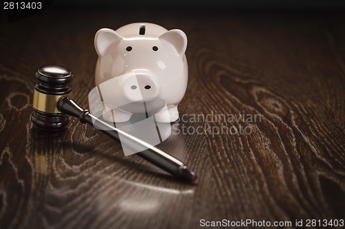 Image of Gavel and Piggy Bank on Table