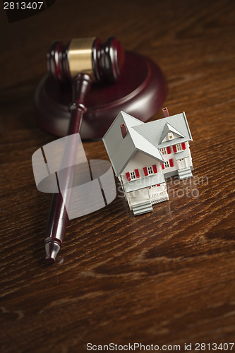 Image of Gavel and Small Model House on Table