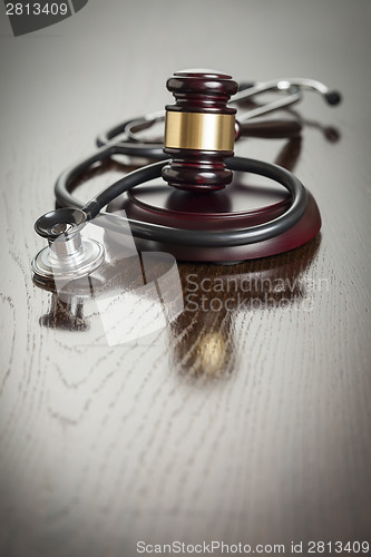 Image of Gavel and Stethoscope on Reflective Table