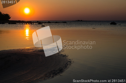 Image of Sand formations at sunset at a calm bay