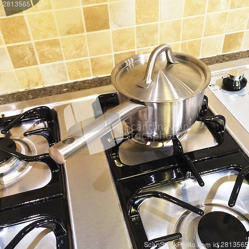 Image of Metal saucepan on gas stove