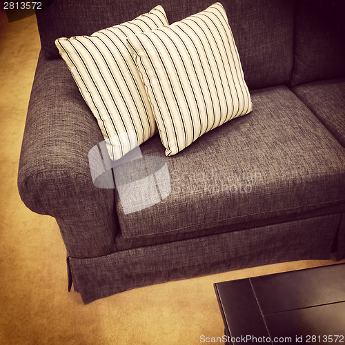 Image of Gray sofa with striped white cushions