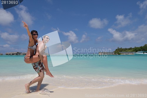 Image of happy young couple have fun on beach