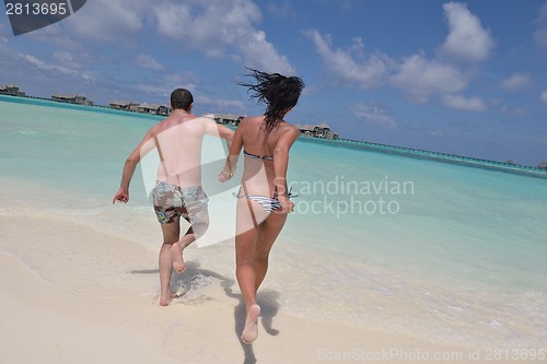 Image of happy young couple have fun on beach