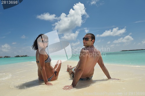 Image of happy young couple have fun on beach