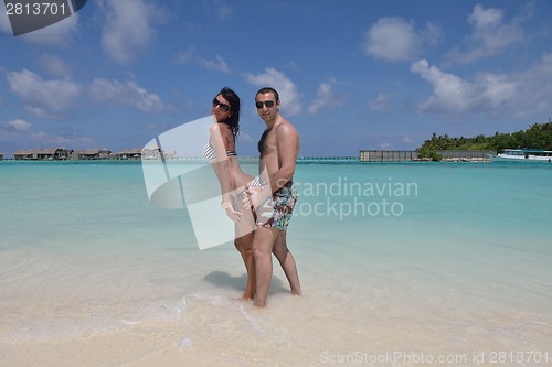 Image of happy young couple have fun on beach