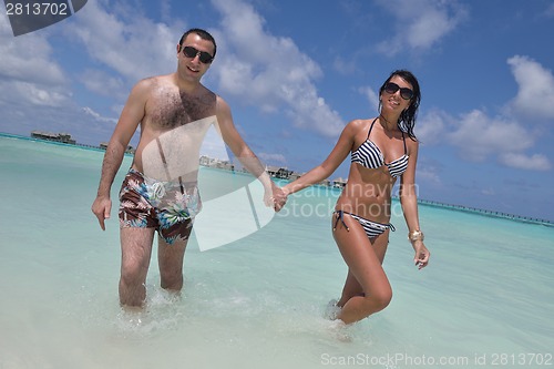 Image of happy young couple have fun on beach
