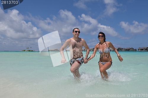 Image of happy young couple have fun on beach