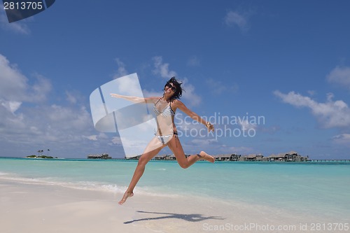 Image of beautiful young woman  on beach have fun and relax