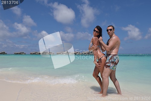 Image of happy young couple have fun on beach