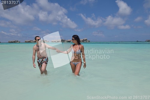 Image of happy young couple have fun on beach