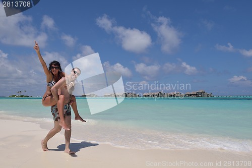 Image of happy young couple have fun on beach