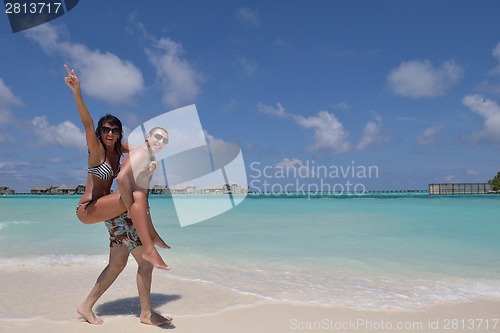 Image of happy young couple have fun on beach