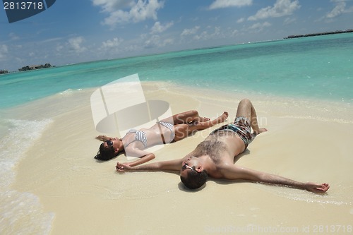 Image of happy young couple have fun on beach