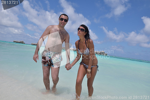 Image of happy young couple have fun on beach