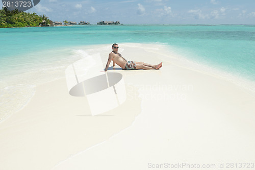 Image of young man have fun and relax on beach