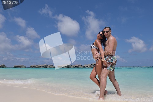 Image of happy young couple have fun on beach