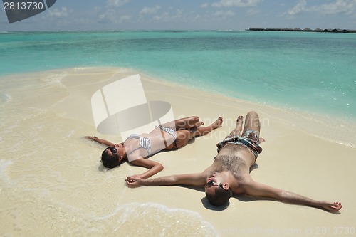 Image of happy young couple have fun on beach