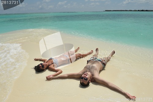 Image of happy young couple have fun on beach