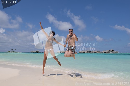 Image of happy young couple have fun on beach