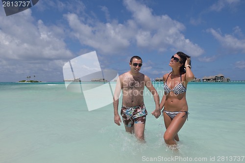 Image of happy young couple have fun on beach