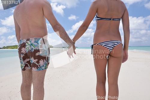 Image of happy young couple have fun on beach
