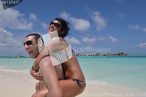 Image of happy young couple have fun on beach