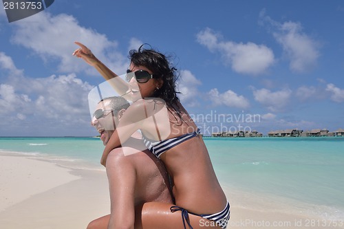 Image of happy young couple have fun on beach