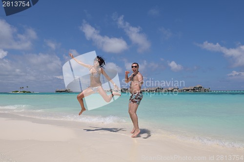 Image of happy young couple have fun on beach