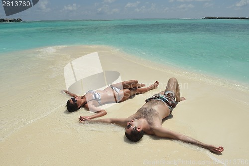 Image of happy young couple have fun on beach