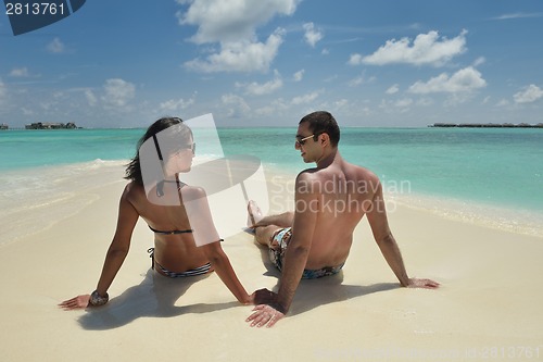 Image of happy young couple have fun on beach