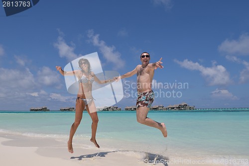 Image of happy young couple have fun on beach