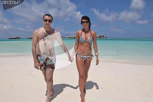 Image of happy young couple have fun on beach