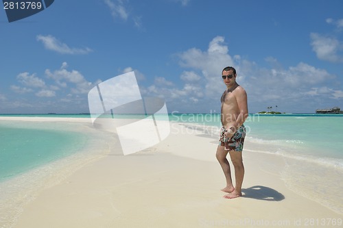 Image of young man have fun and relax on beach