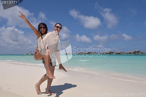 Image of happy young couple have fun on beach