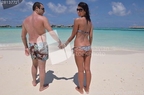 Image of happy young couple have fun on beach